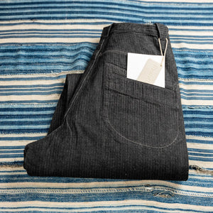 MotivMfg Pleat Herringbone Denim Trousers Black Classic Straight folded