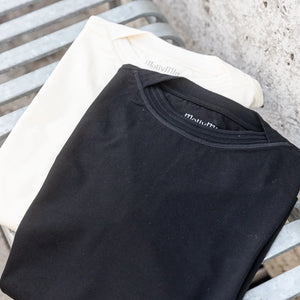 MotivMfg Supima Cotton Silk Shuttle TShirt Ivory folded together with black