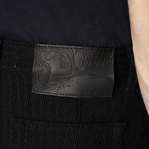 Naked and Famous 12 ounce Sugiaya Dobby Herringbone Pleated Trouser Black Sugiaya Relaxed Straight close up leather patch